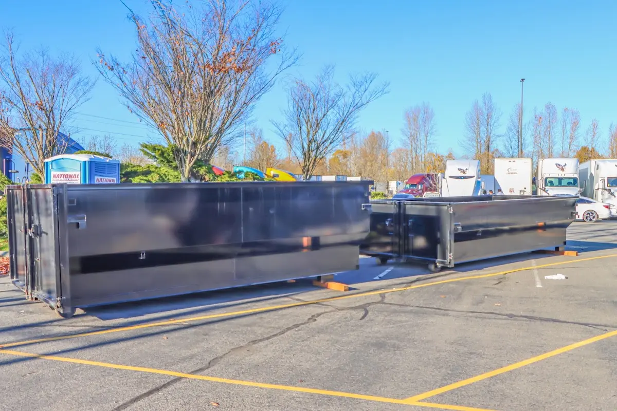 Professional dumpster rental service with roll-off container on residential driveway in Sault Ste. Marie
